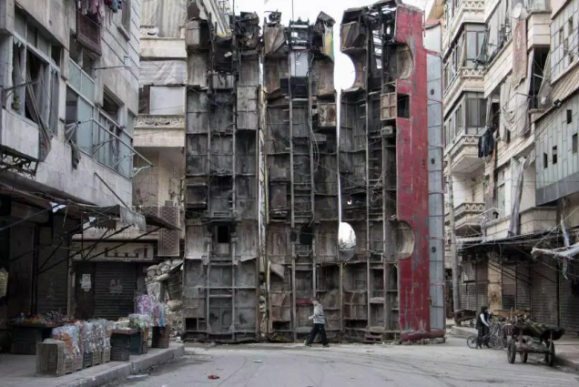 Em março de 2015, ao norte da cidade síria de Aleppo, um garoto passou por uma barricada improvisada, feita com restos de ônibus. A barricada estava sendo usada para obstruir o campo de visão de snipers do regime de Assad e manter os civis em segurança. Em março de 2015, ao norte da cidade síria de Aleppo, um garoto passou por uma barricada improvisada, feita com restos de ônibus. A barricada estava sendo usada para obstruir o campo de visão de snipers do regime de Assad e manter os civis em segurança.