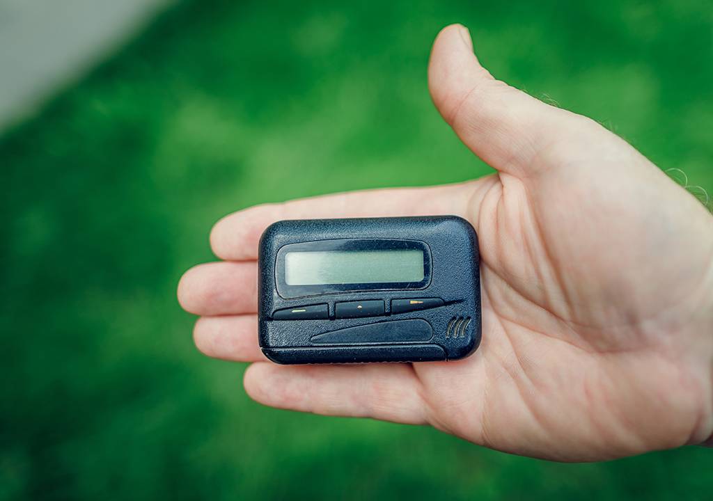Uma mão segurando um pager.